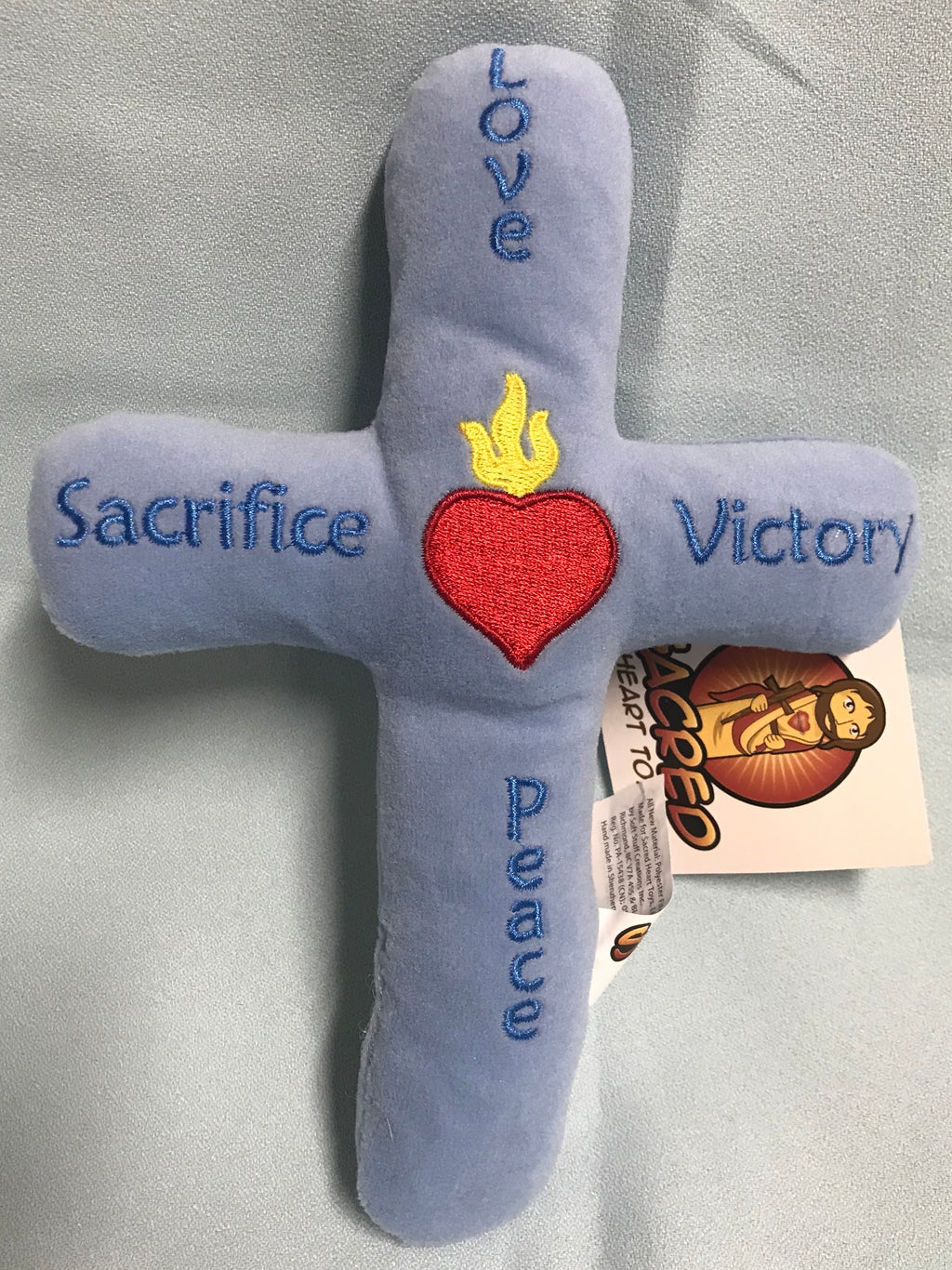Blue plush toy cross.