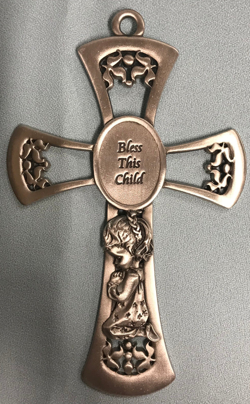 Silver colored cross says, "Bless This Child." It shows a girl kneeling and praying.